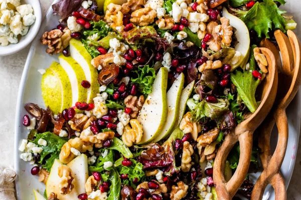 A salad with pears, walnuts and pomegranate.