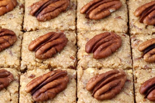 Pecan bars with pecans on top.