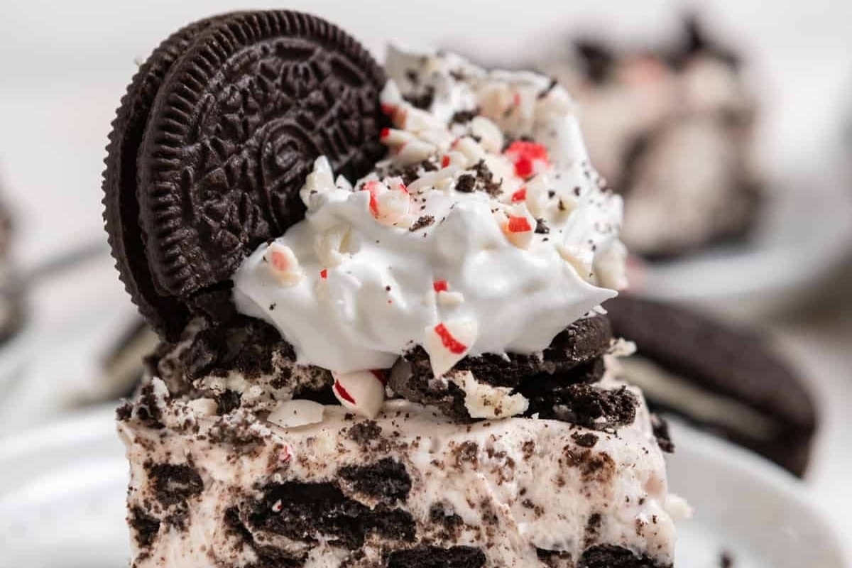 Christmas-themed Oreo cheesecake with peppermint whipped cream and oreos.