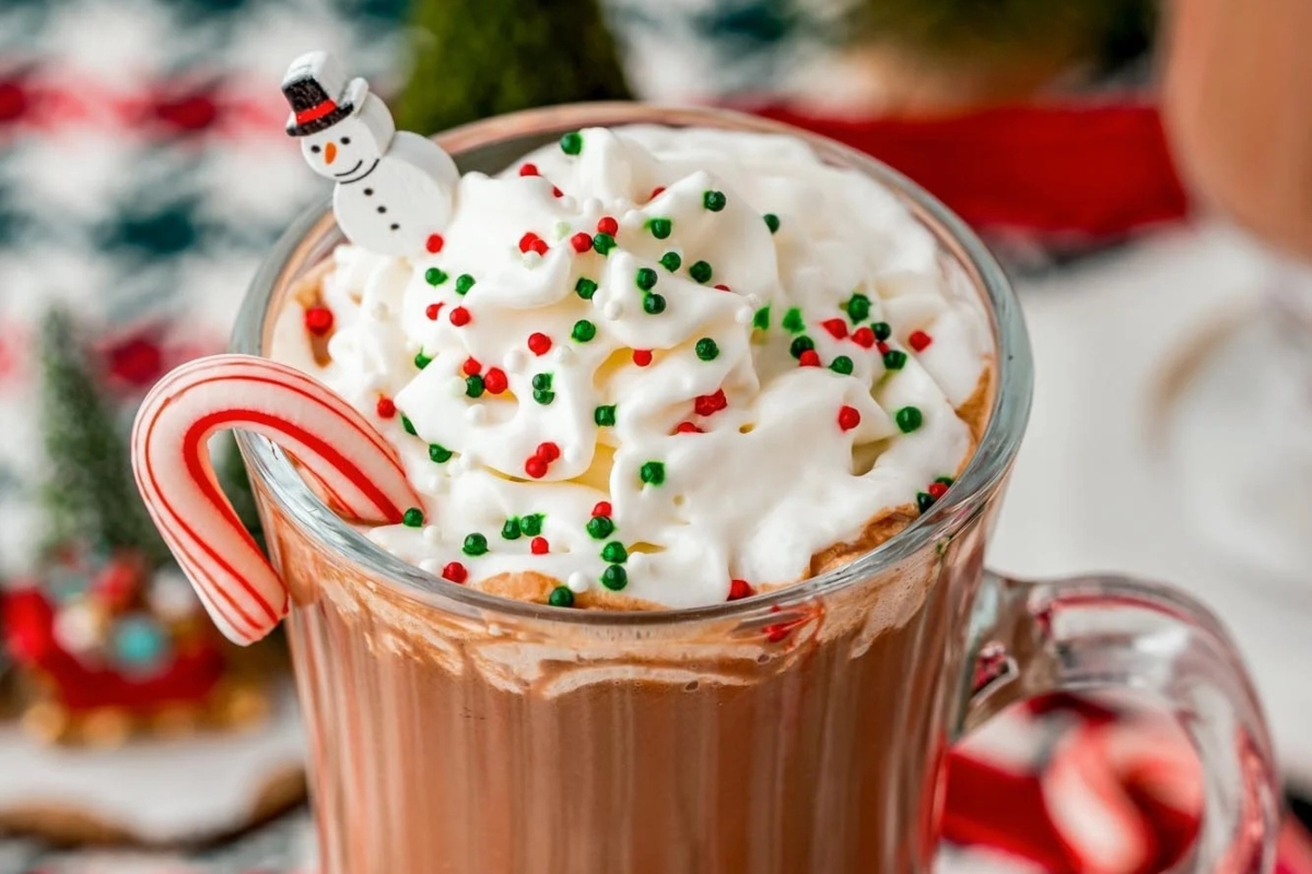 A festive holiday treat, this Starbucks-inspired hot chocolate recipe is enhanced with the indulgent addition of whipped cream and candy canes.