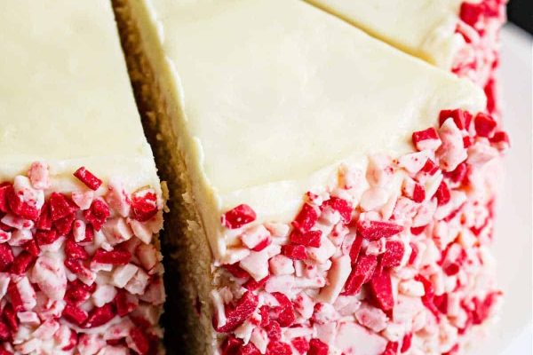 A white cake with red and white sprinkles on top.