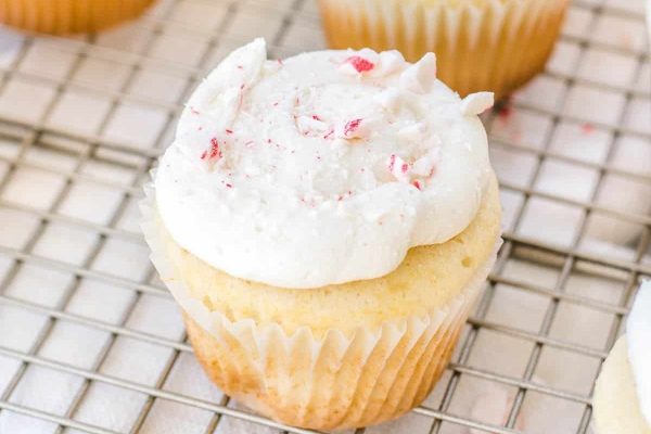 Christmas-themed peppermint cupcakes on a cooling rack.