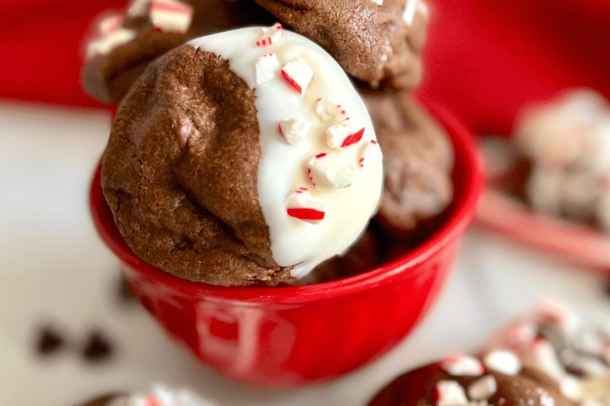 Candy cane chocolate peppermint cookies in a red bowl.