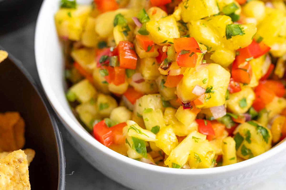 Pineapple salsa in a bowl with tortilla chips.