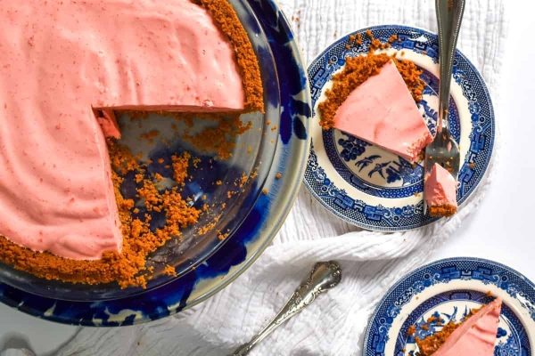 A slice of strawberry pie on a plate with a fork. (No changes made)
