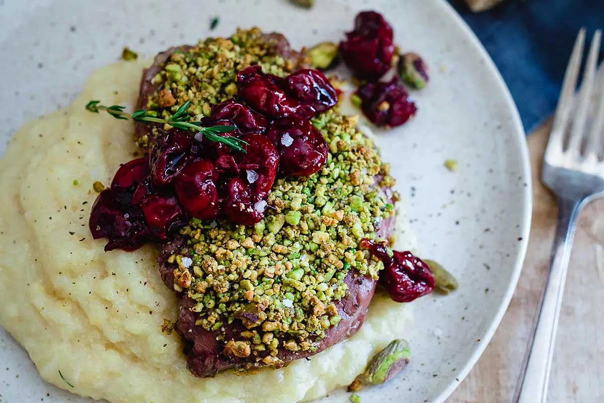 Pistachio Crusted Lamb Chops with Red Wine Cherries