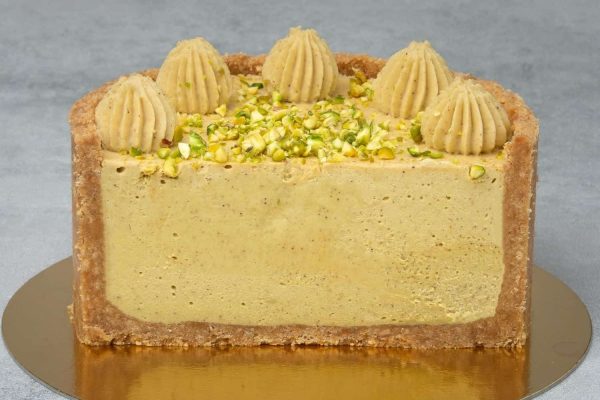A cake with pistachios on top of it.