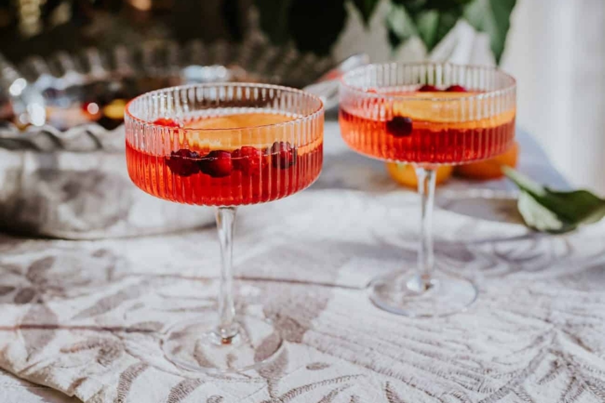 Two glasses of cranberry cocktail on a table.