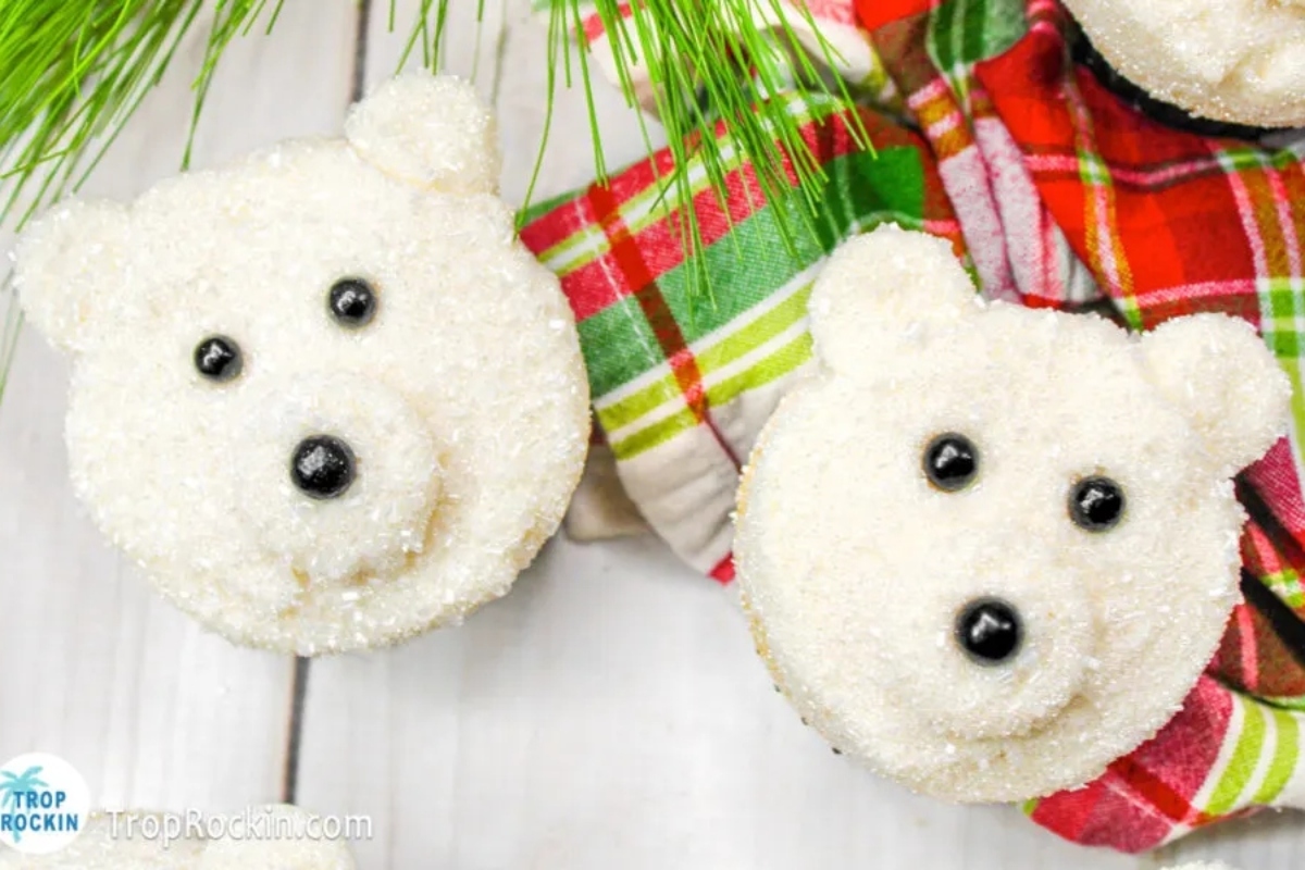 Cute polar bear cupcakes decorated with Christmas frosting and pine cones.