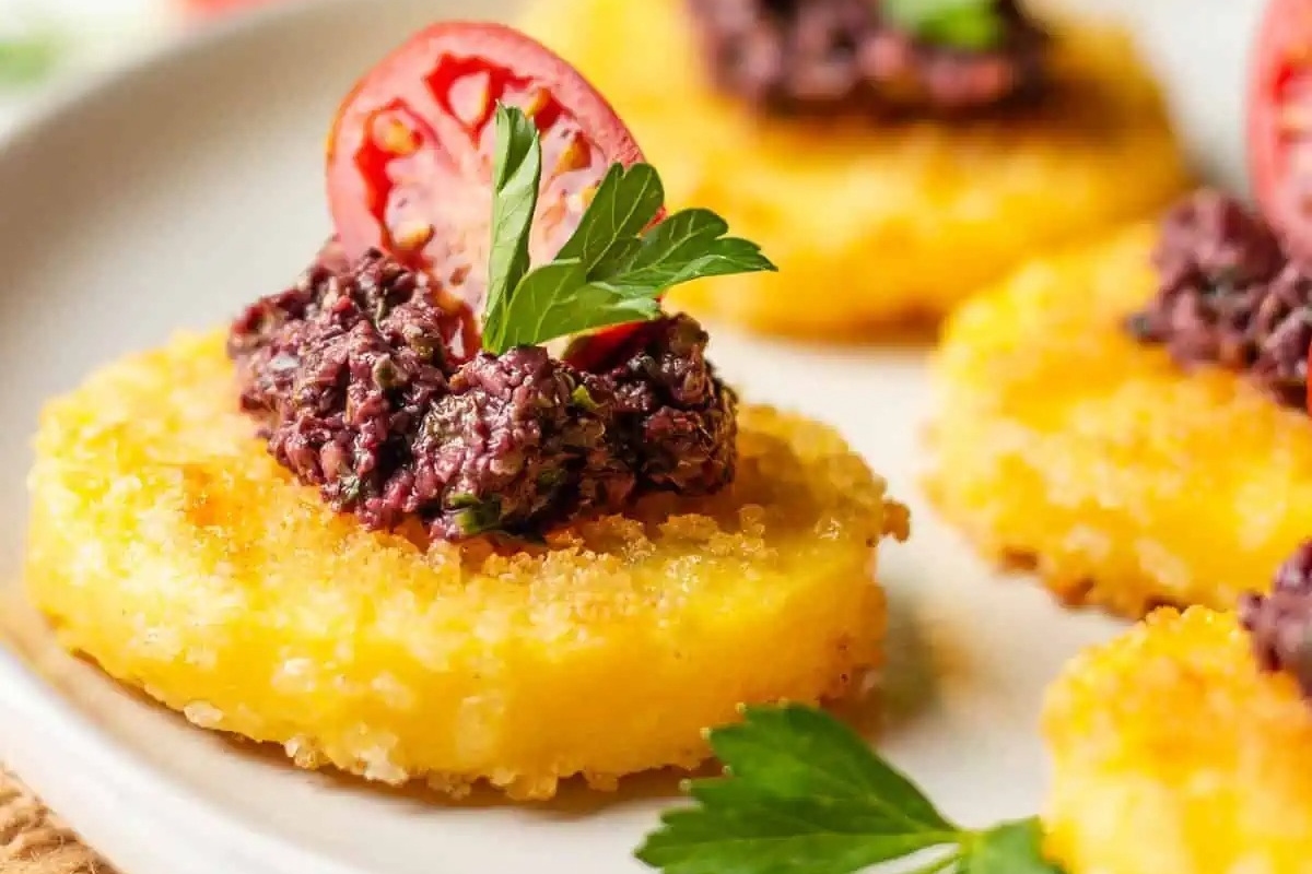 A festive plate of Christmas appetizers with black bean and tomato toppings.