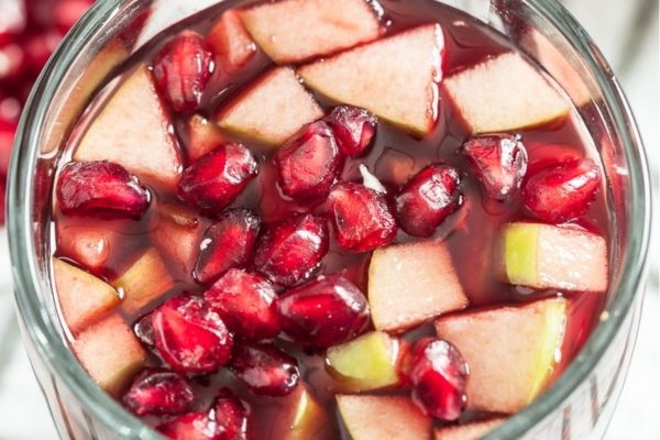 Pomegranate sangria in a glass bowl.