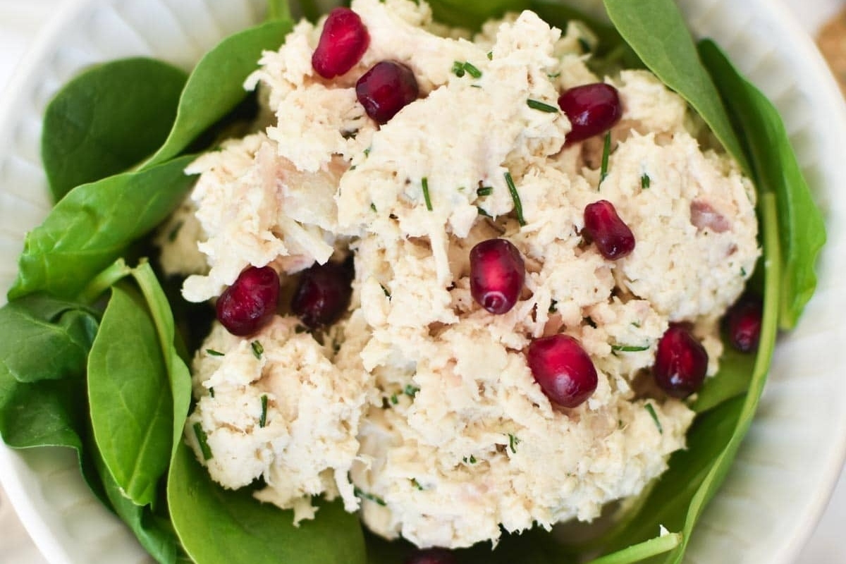 A refreshing chicken salad recipe that combines tender chicken with fresh spinach and vibrant pomegranate seeds.