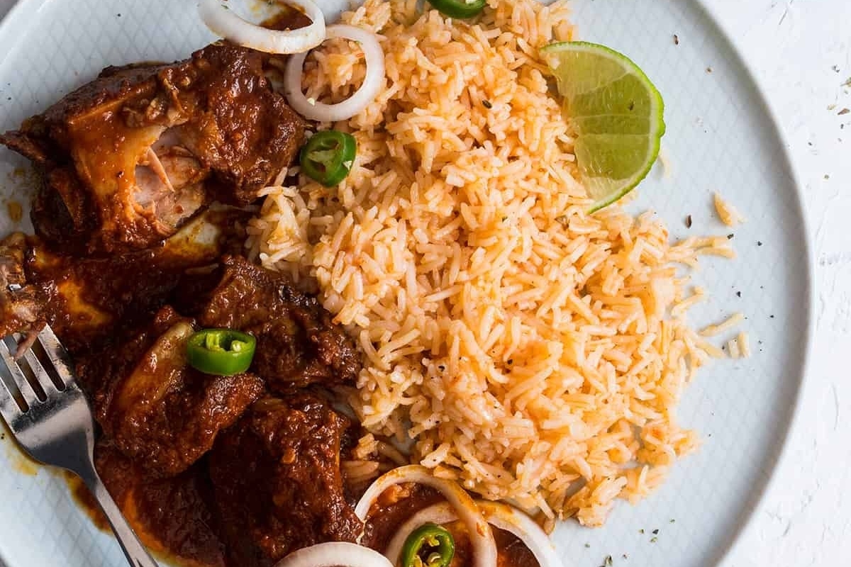 A mouthwatering plate with rice and succulent meat on it, perfect for those who love ribs.