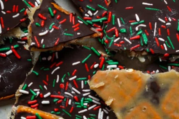 A piece of chocolate bark with sprinkles on it.