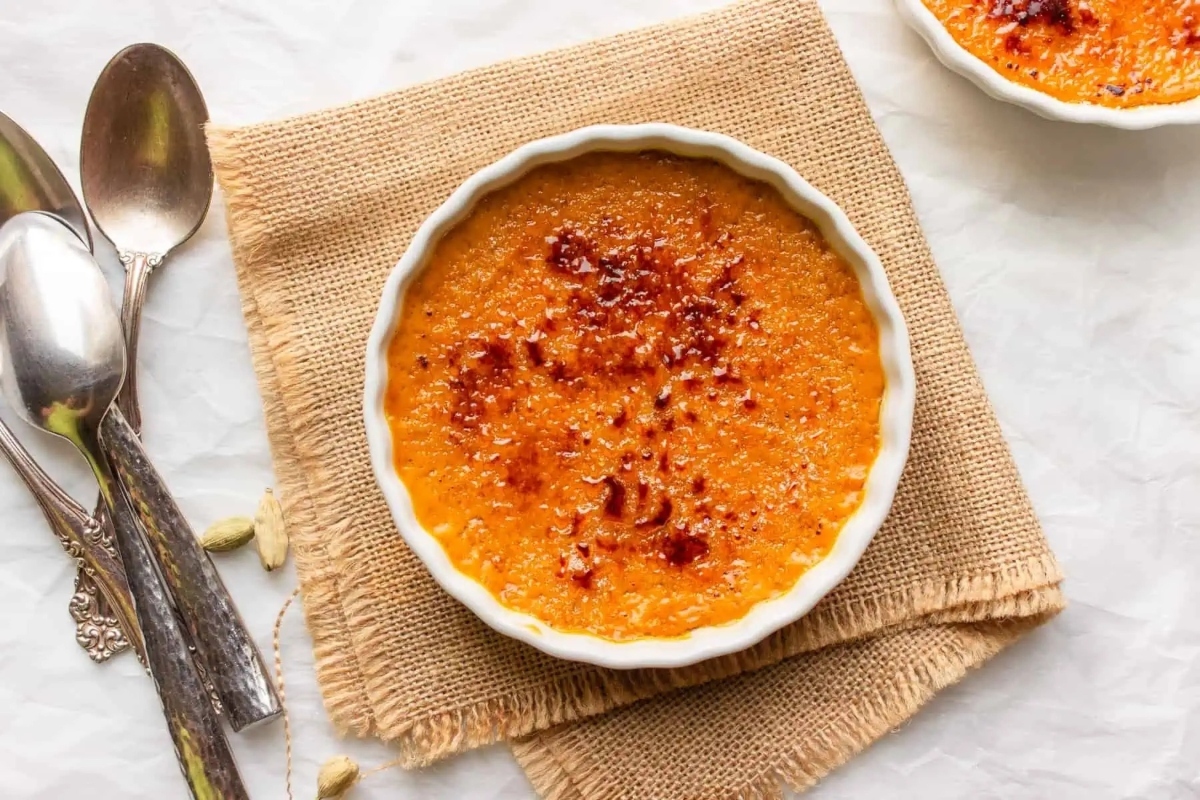 An elegant Thanksgiving dessert, showcasing two bowls of orange pudding.
