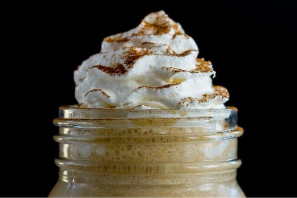 A pumpkin spice latte with whipped cream.