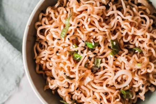 Ramen noodles in a bowl with green onions.