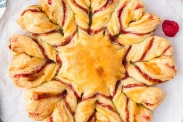 A pastry with raspberries and raspberries on top.