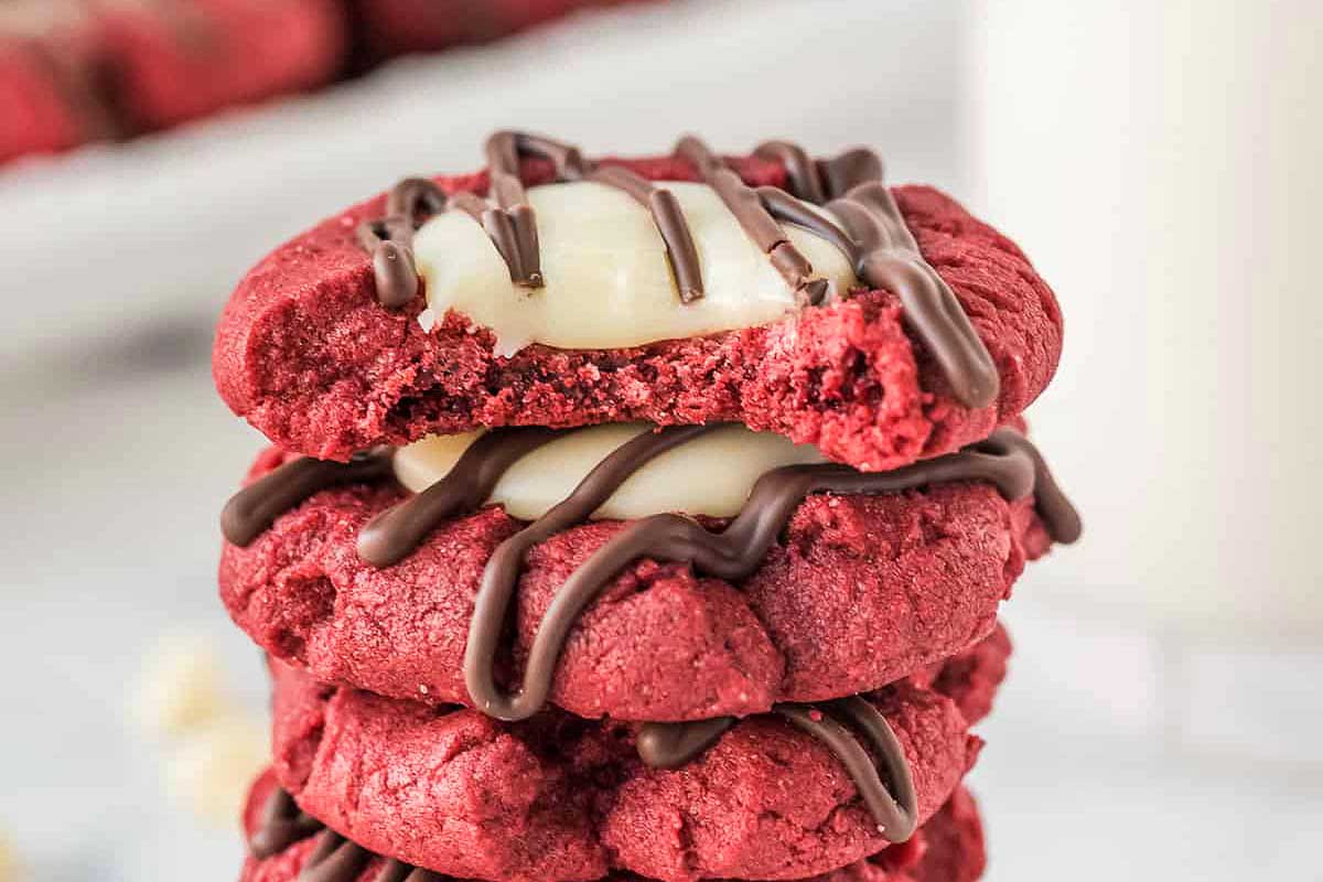 Red velvet thumbprint cookies drizzled with chocolate.