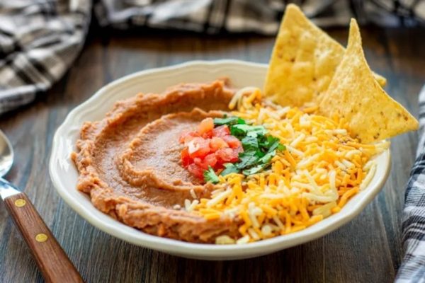 A delectable recipe for Mexican hummus using pantry staples, served with crispy tortilla chips and zesty salsa.