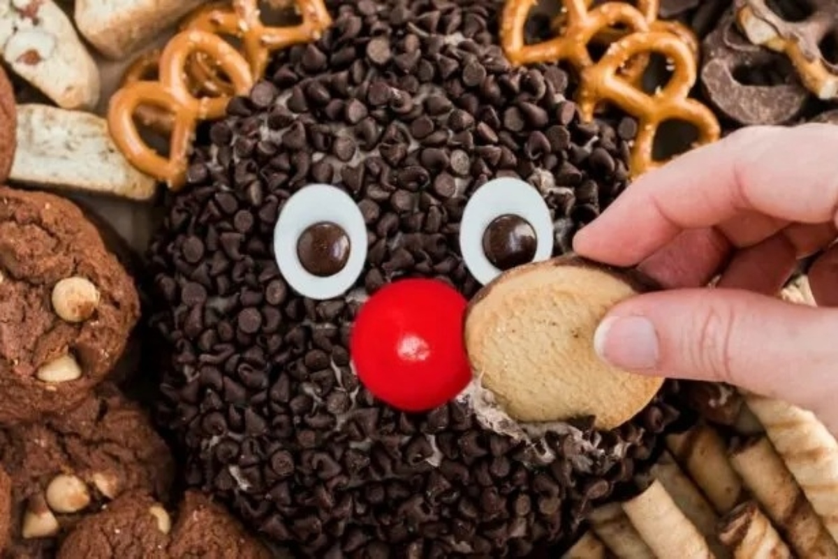 A person is holding a Christmas cookie.