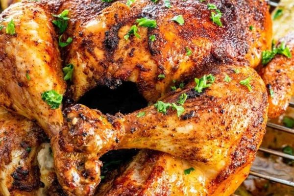Roast chicken with herbs on top.