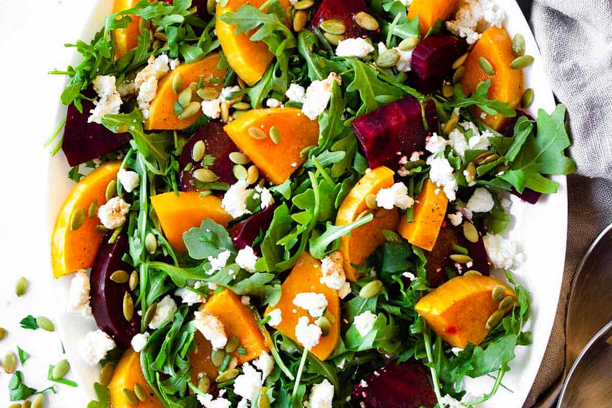 A salad with beets and feta on a white plate.