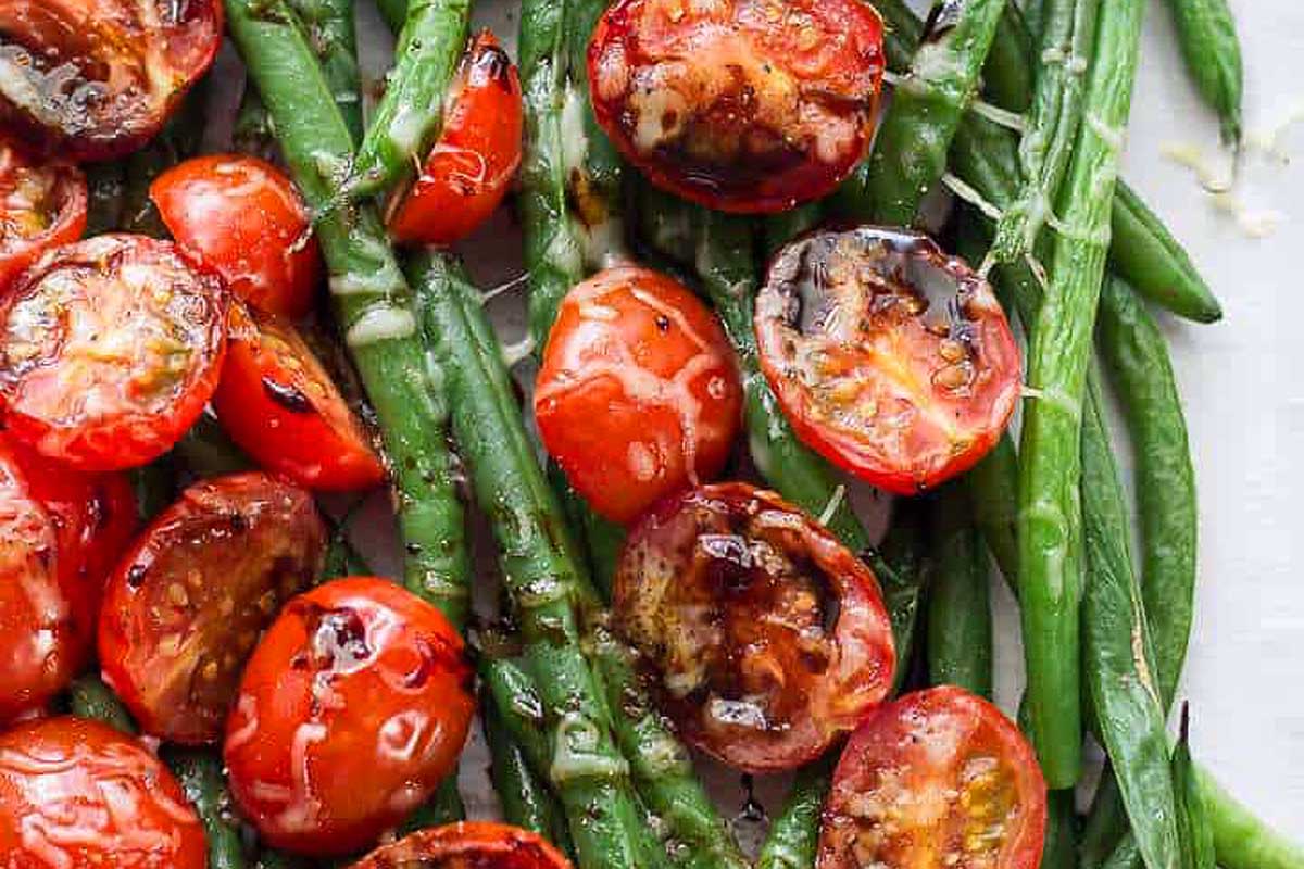 Fresh tomato recipes featuring green beans, served on a white plate.