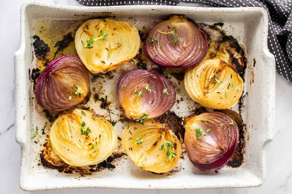 Sides: Roasted red onions on a baking sheet.