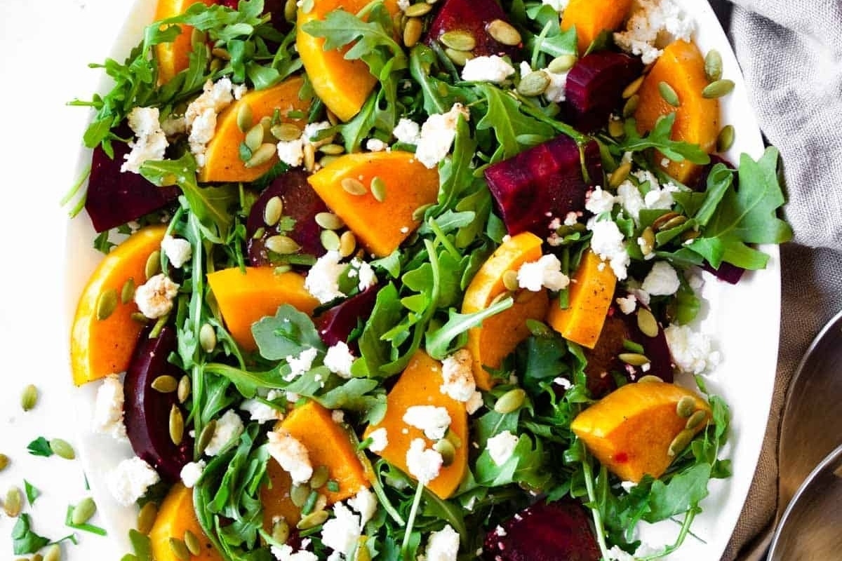 Elegant beet and goat cheese salad on a white plate, perfect for Thanksgiving.