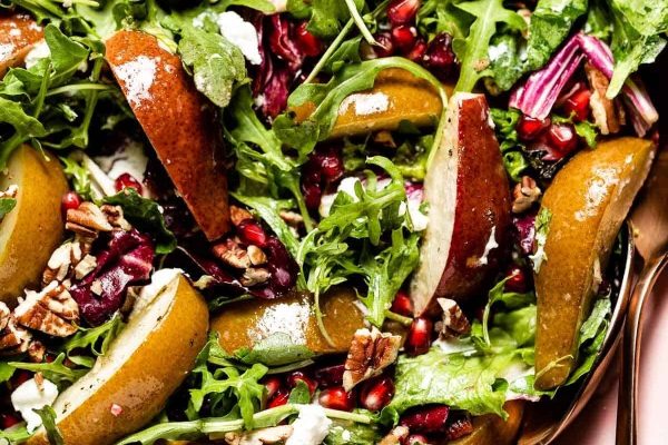 A salad with pears, walnuts and pomegranate.