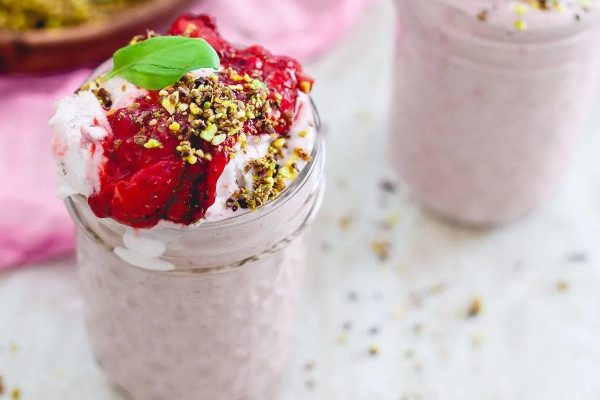 Two jars of smoothie with strawberries and pistachios – perfect for milkshake lovers looking for unique recipes!