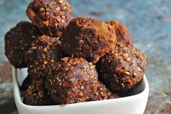 Traditional chocolate truffles in a white bowl.