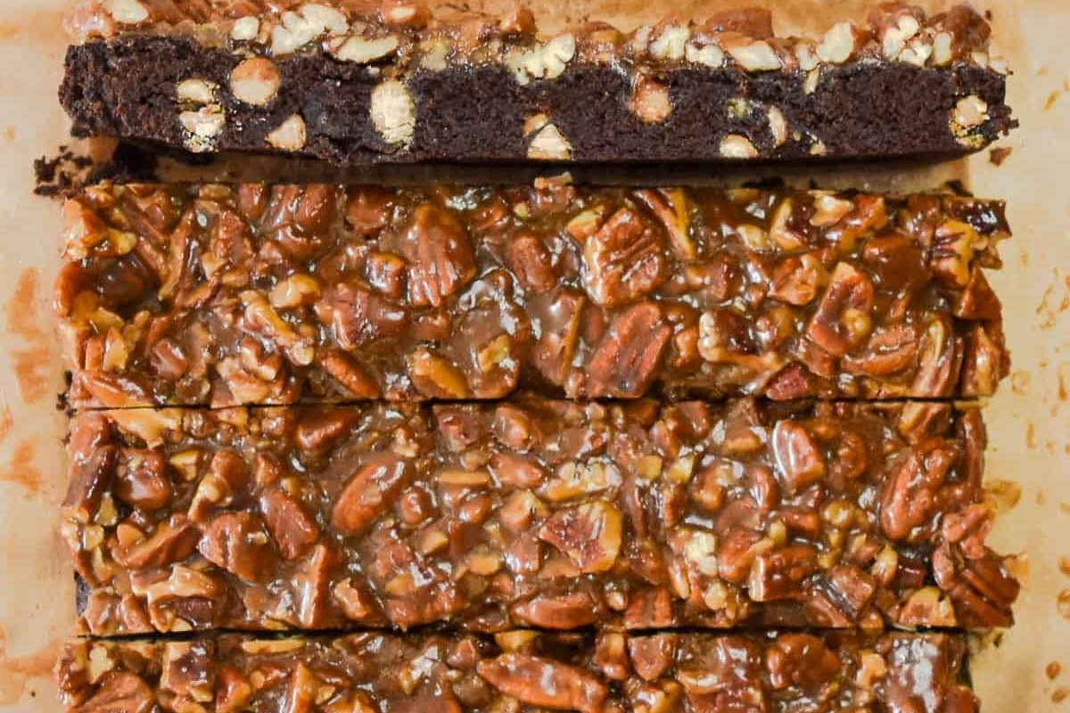 Pecan bars with caramel and pecans in a baking pan.