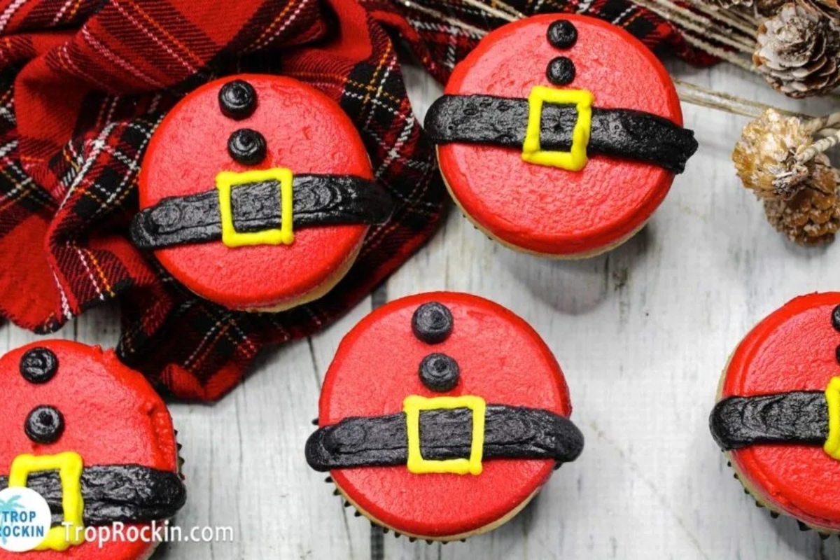 Cute Christmas cupcakes on a wooden table.