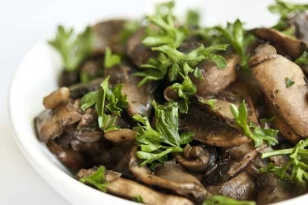 Mushroom recipes in a white bowl with parsley.