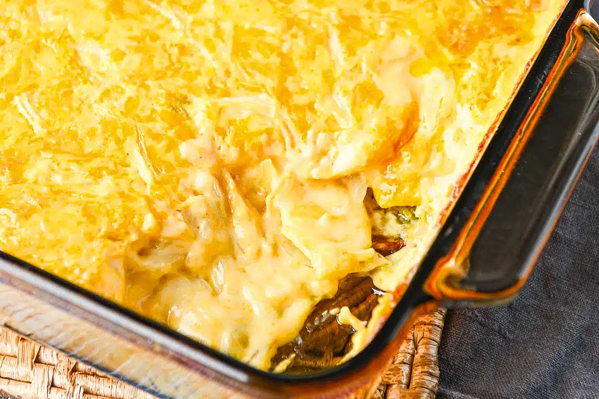 A casserole dish filled with cheese and vegetables.
