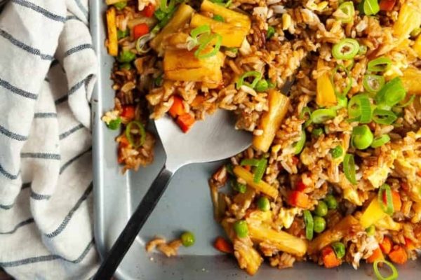 Fried rice in a pan with a spoon.