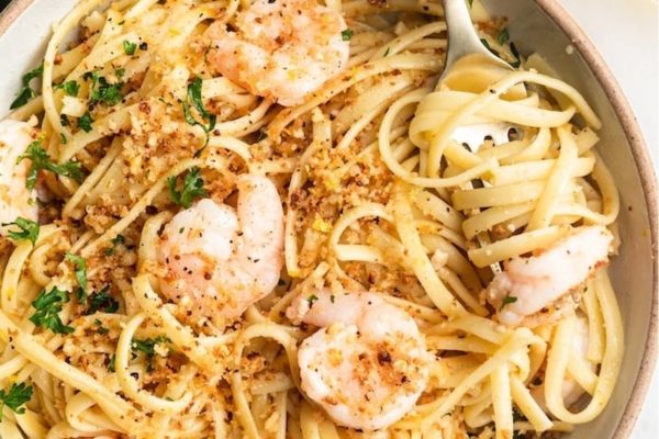 A bowl of pasta with shrimp and parmesan.