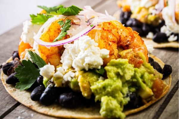 Shrimp tostadas with black beans and guacamole.