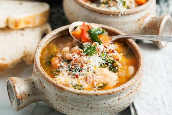 A simple and flavorful white bean and spinach soup made with just a few ingredients, served with freshly baked bread.