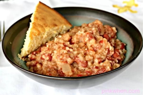 A simple and nourishing recipe featuring a combination of beans and corn, accompanied by a piece of bread. This dish is perfect for utilizing pantry staples to create a delicious and wholesome meal.
