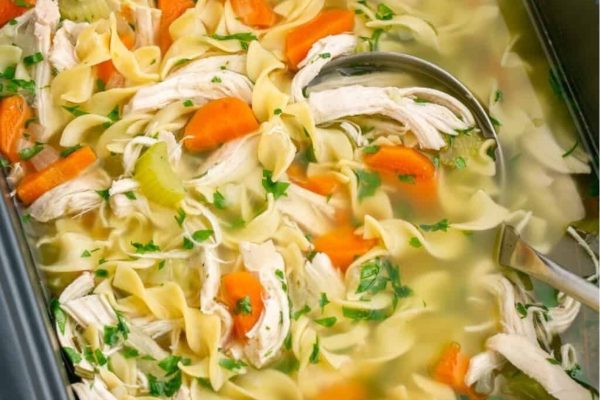 Chicken noodle soup in a slow cooker.