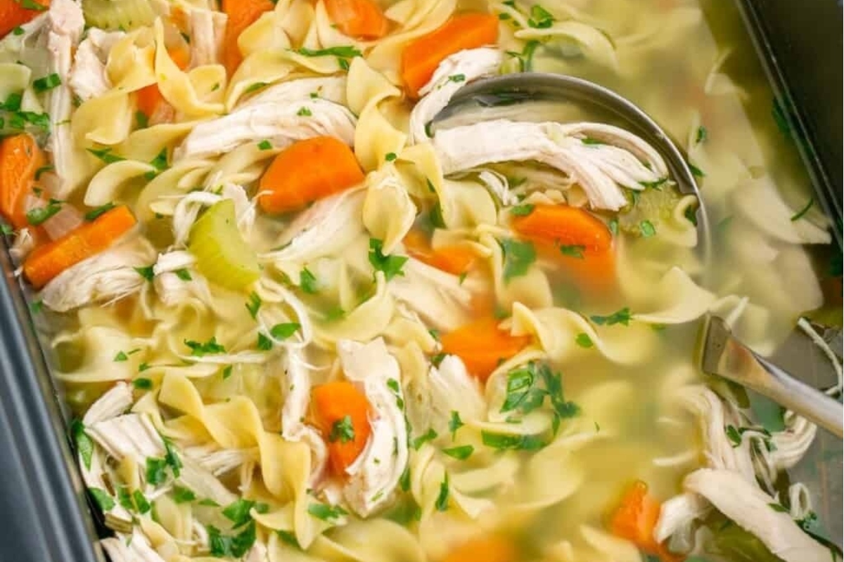 Chicken noodle soup in a slow cooker.