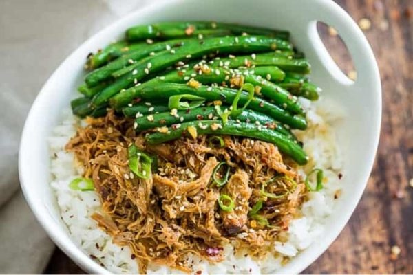 A white bowl filled with rice and green beans.
