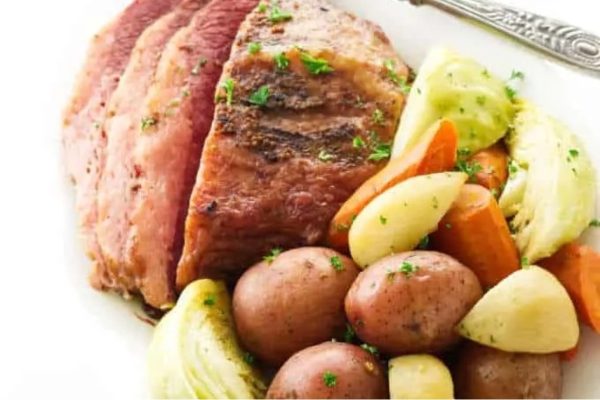 Corned beef and cabbage on a white plate.
