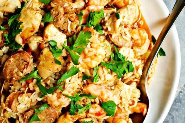 A bowl of shrimp and rice with a spoon.