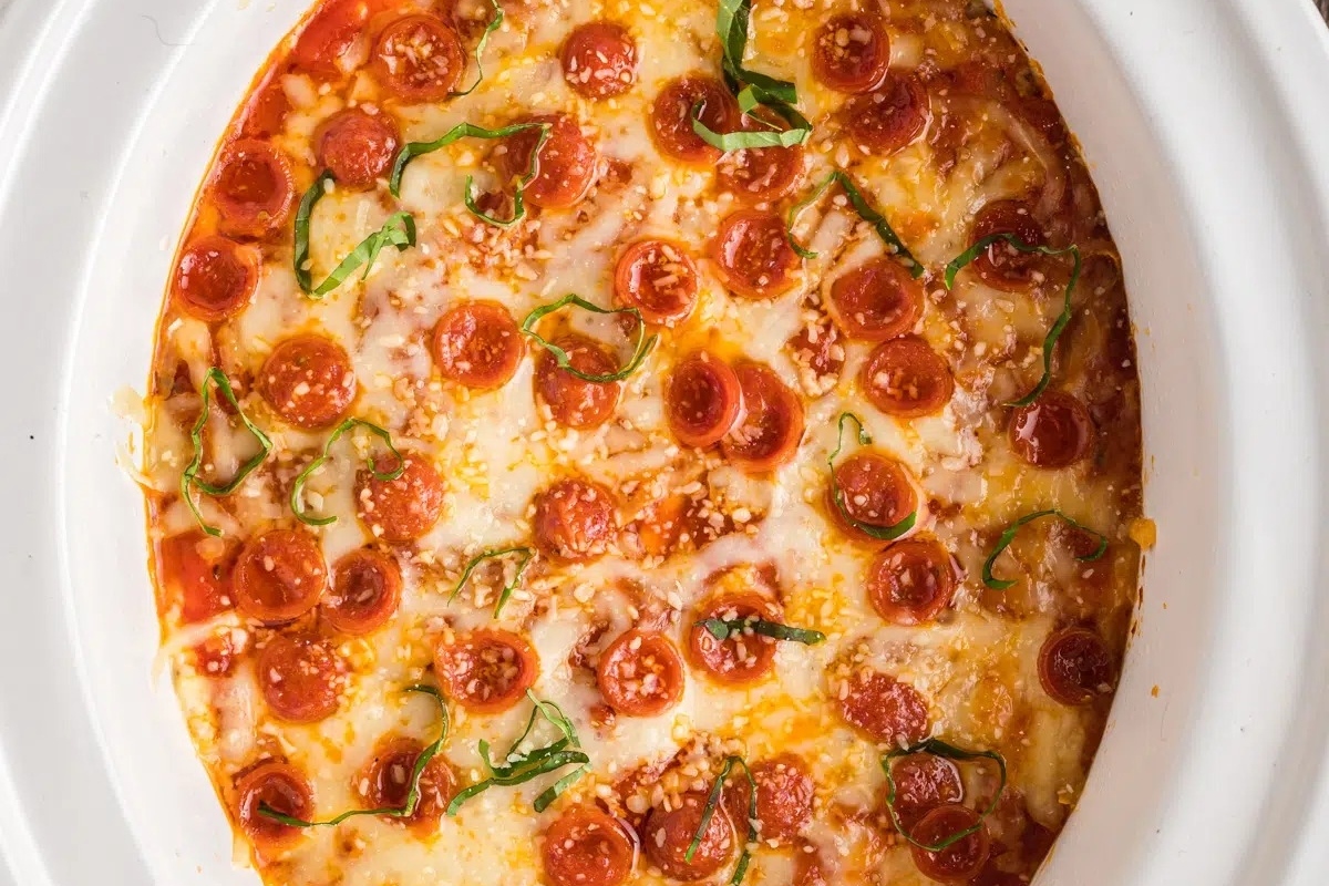 A slow-cooked pizza dip served in a crock pot.