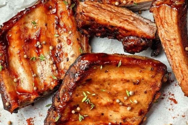 Bbq ribs on a plate with herbs and spices.