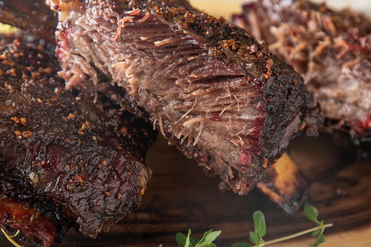 Mouthwatering bbq ribs on a wooden cutting board.